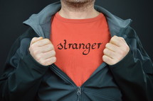 a man with the word stranger on his red t-shirt 