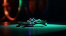 Two wedding rings in a neon lit dark room. 