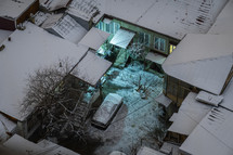 Snowy houses and yard at night