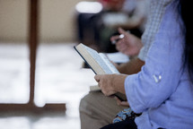 group of people reading Bibles 