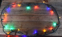 Border of Christmas Lights on wooden background