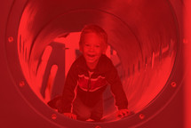 kid on a playground in red