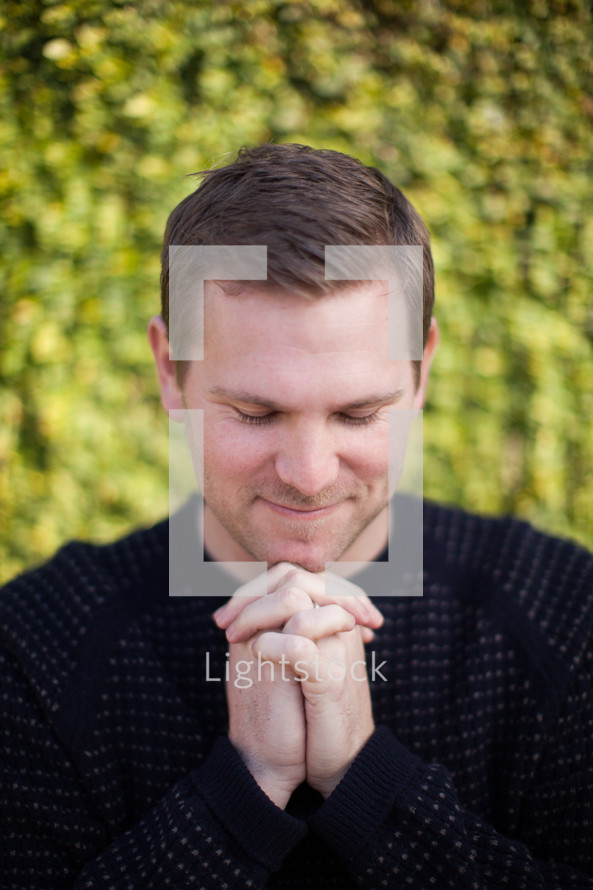 closeup of a man with praying hands 