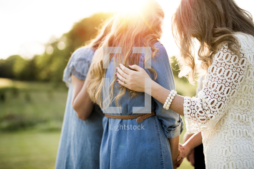 group of women holding Bibles outdoors 