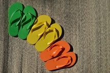 colorful flip flops on a beach mat 