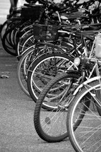 lots of bicycles, 
bicycle, bike, bikes, bicycles, cycle, cycles, ride, riding, mobile, sport, sports, outdoor, lot, many, plenty, much, mobility, acitve, actively, action, move, engage, travel, along, park, parked, parking, layby, monochrome, black, white, grey, biking
