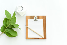 clipboard, paper, pencil, twig, greenery, green leaves, plant, votive 