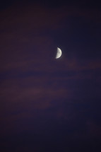 crescent Moon at twilight with magenta clouds.