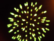 Green fireworks exploding in the night sky.