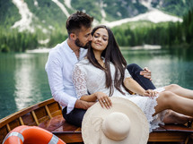 a couple cuddling on a rowboat 