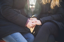 women holding hands in prayer 