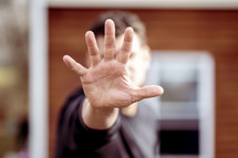 a man with his hand up - stop 