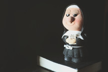 nun, Figurine, holding, BIBle, good book 