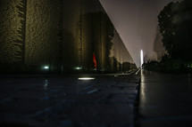 Vietnam Memorial with Washington Monument  in background, taken at night