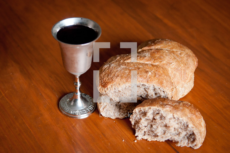Broken bread and a chalice of wine.
