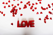 word love and red hearts on a white background 