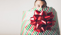 A man wrapped as a Christmas present
