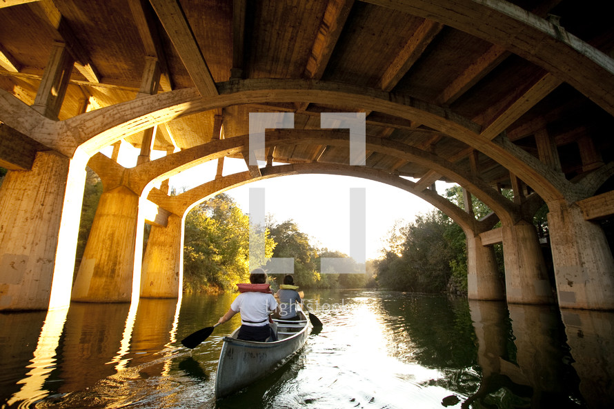 canoe under a bridge 