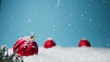 Red Christmas balls in a snowy background 