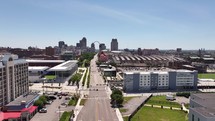 Aerial drone footage of Saint Louis, Missouri flying down Market street with traffic and the soccer stadium on a bright blue sky sunny day.