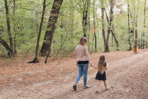 mother and daughter walking holding hands 