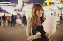 Woman with cotton candy at carnival