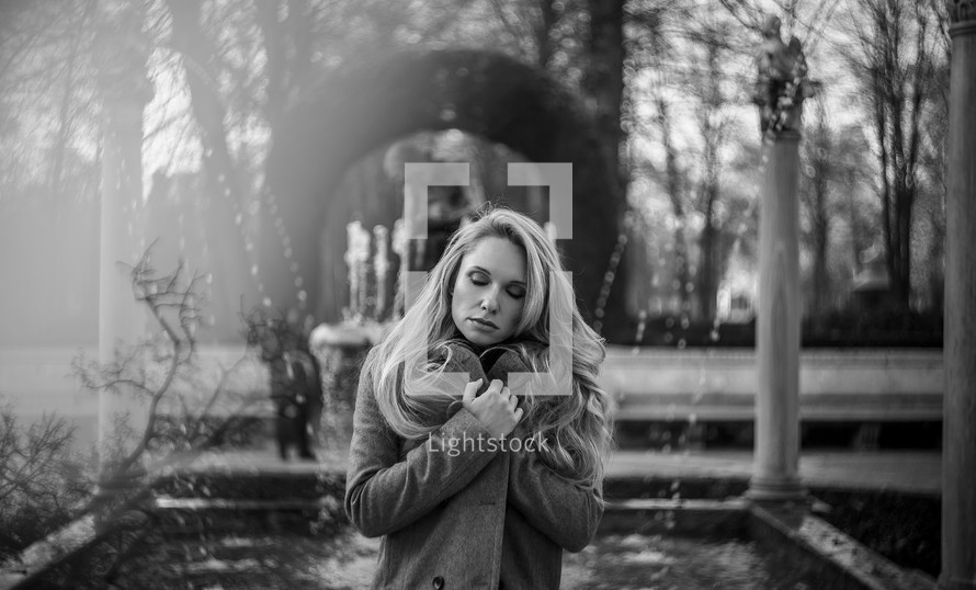 a woman hugging herself in the cold 