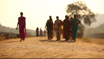 women walking down a desert 