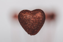 red glittery heart and blurry background 