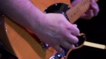 Close up of a lead guitarist playing live onstage