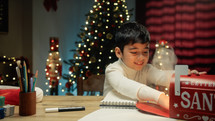 Kid sending Christmas letter to Santa Claus letterbox