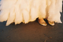 brides shoes under her bridal dress