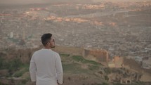 Man looking to Panoramic view of Medina Old Town Fes Fez Morocco during Sunset
