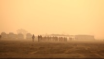 people walking in a desert 