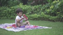Smart Happy Asian Indonesian Child Playing and Learning with Toys Accompanied By The Parents - Family Time at Garden