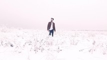 man walking through the snow 