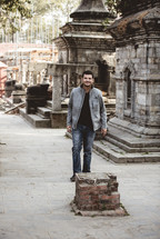 man standing near ruins in Nepal 