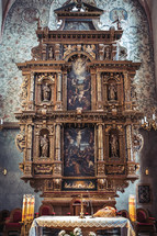 A medieval high altar with sculptures and paintings in basilica in Poland.