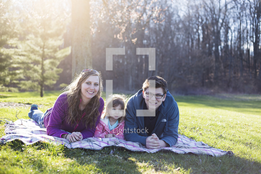 family on a blanket outdoors 