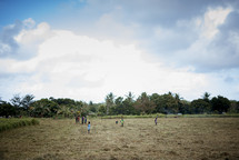 village children playing in a field 