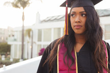 female African American graduate in cap and gown 