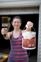 girl holding a can of paint 