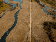 aerial view over a dirt road and rivers 