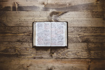opened Bible on a wood background 