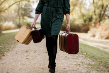 a woman walking carrying luggage 