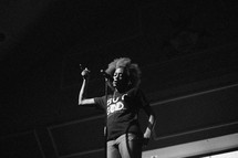 a woman singing into a microphone 