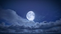 Timelapse of full moon night and starry blue sky with moving clouds. The moon on cloudy sky. Christmas night background. Beautiful cloudscape
