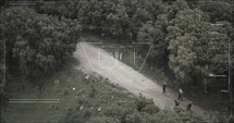 Military surveillance drone view of terrorists walking through a forest