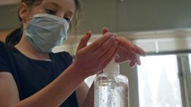 Corona pandemic - Girl using hand sanitizer to prevent coronavirus spread