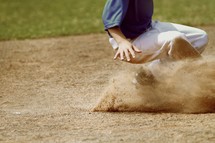 a boy sliding in baseball